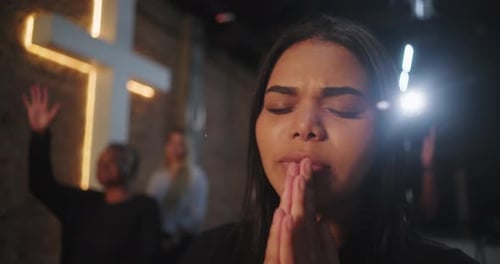 Diverse group of people praying and connecting emotionally in spiritual setting, hands clasped