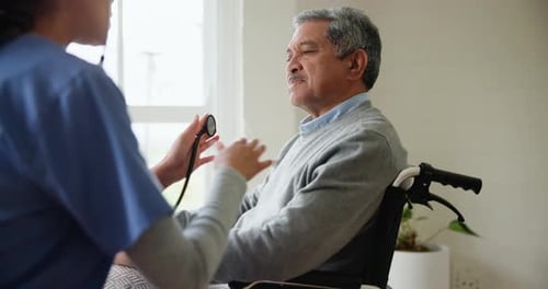 Senior Man Receiving Heart Exam from Nurse