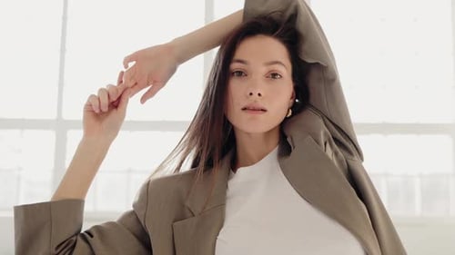 Elegant Woman Posing in Bright Studio