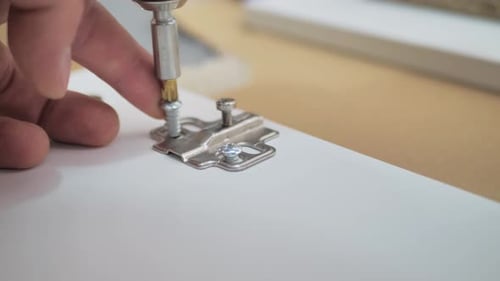 Tightening Screw into White Board for Furniture
