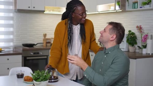 Loving Couple Enjoying Coffee Together in Modern Kitchen