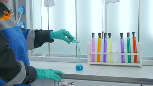 Scientist Mixing Liquids in Laboratory Experiment