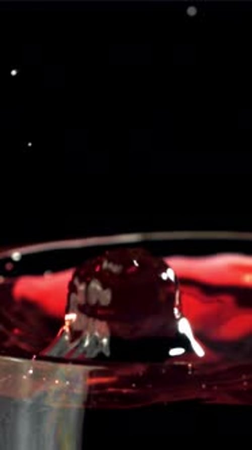 A Drop Falls Into a Glass of Wine On a Black Background Filmed on a Highspeed Camera at 1000 Fps
