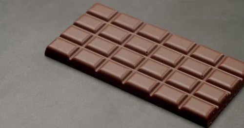 Closeup Of A Delicious Dark Chocolate Bar On Dark Background