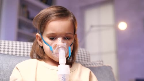 Girl Using Nebulizer for Respiratory Treatment