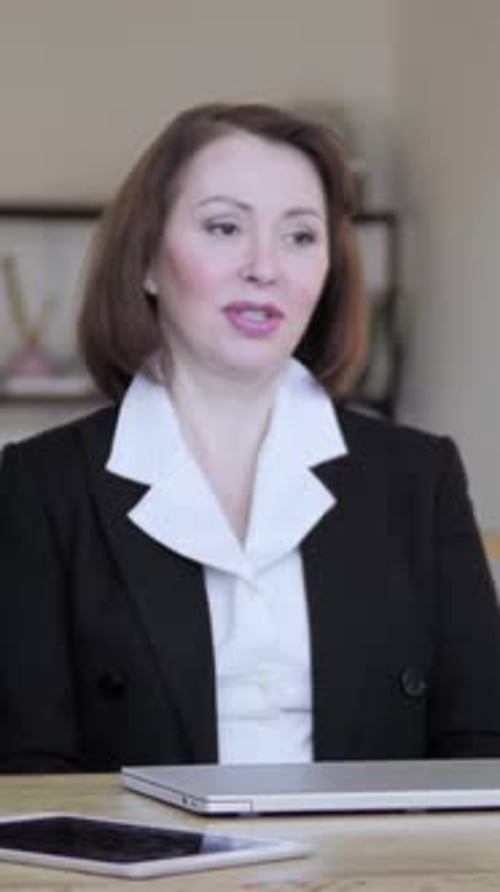 Adult Woman Talking at a Meeting Indoors