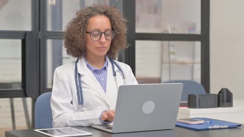 Female Doctor Working on Laptop in Office