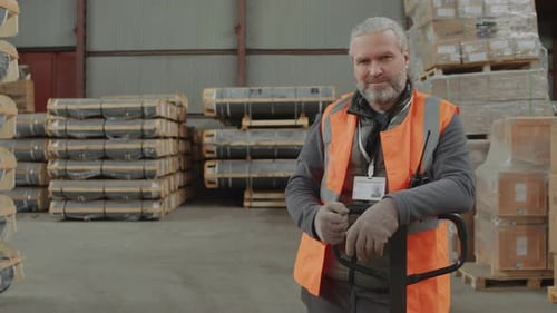 Man With Gray Hair Standing in Warehouse