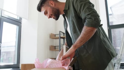 Moving, People and Real Estate Concept - Happy Smiling Man with Boxes