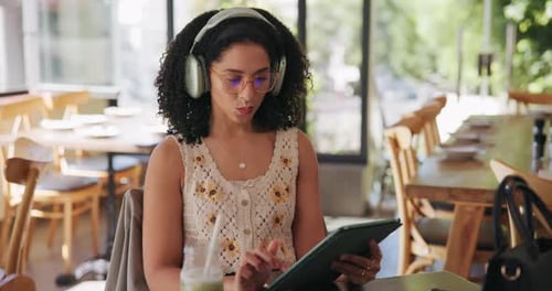 Remote work, headphones and woman with tablet in cafe with drink for freelancer