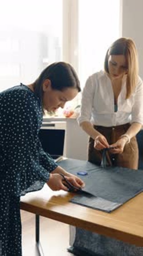 Female Fashion Designers Collaborating in a Studio