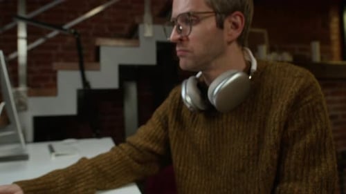 Male Developer Starting His Workday in Modern Office