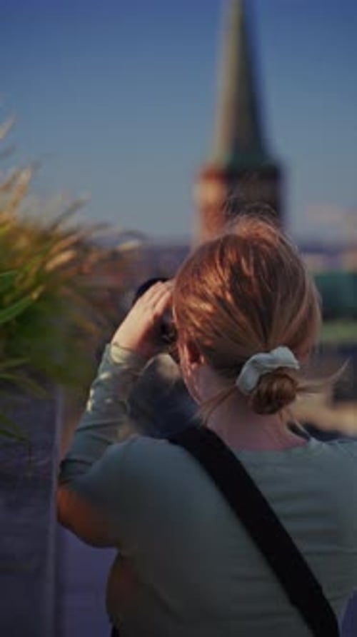 Woman Taking Pictures in an Urban Location