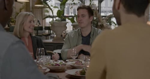Family and Friends Enjoying Dinner in Restaurant Together