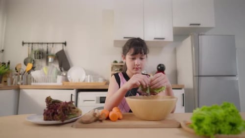 Girl Prepares Healthy Salad in Modern Kitchen