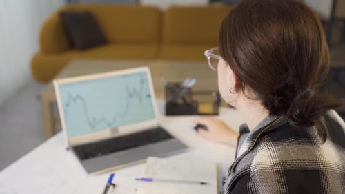 Woman examining crypto chart.