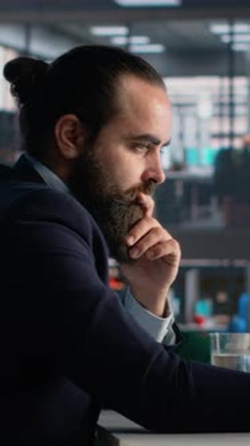 Vertical Video Businessman Engaged in Data Analysis for Company Productivity and Performance