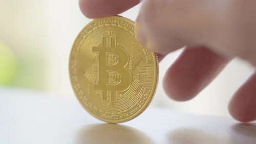 Hand Holding Gold Bitcoin Cryptocurrency Coin Close Up