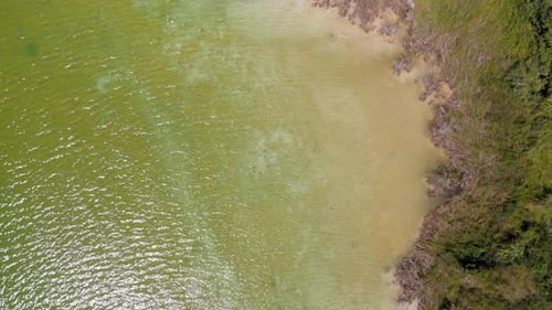 Drone aerial view of village with bungalows near a lake in Mexico