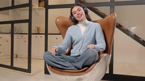 Woman Listening to Music in Modern Chair