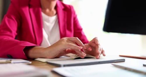 Woman Typing on Keyboard at Bright Desk