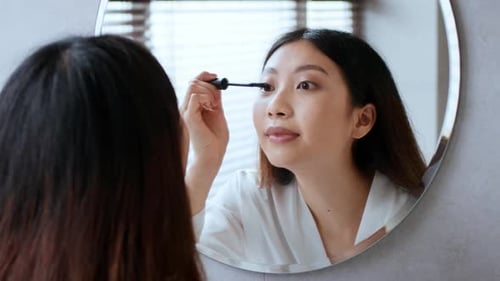 Young Woman Enjoys a Selfcare Routine in a Relaxing Bathroom Setting