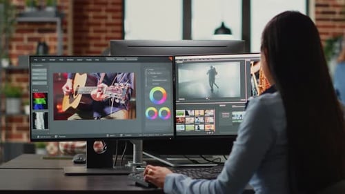 Woman Edits Video and Graphics on Dual Monitors