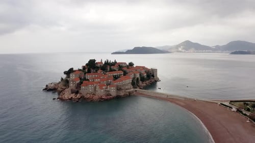 AERIAL - Sveti Stefan luxury resort island in the Adriatic Sea, Montenegro, reverse