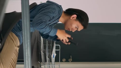 Vertical Video Asian Web Developer Programming Firewall Server on Terminal Window