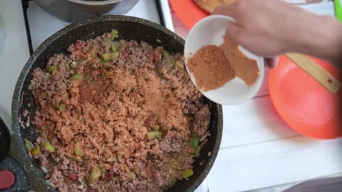 Cooking Pasta Bolognese at Home Male Cooking Tasty Pasta Tomato Sauce in Kitchen Add Spices