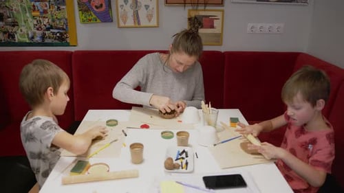 Mother Trying to Work with Lousy Kids during Remote Pottery Workshop