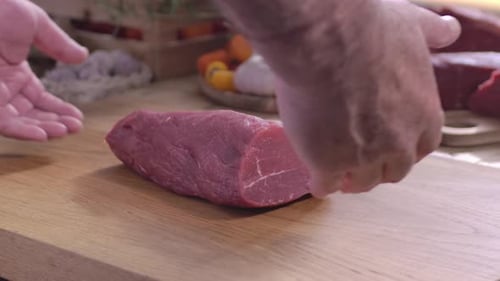 Raw Beef Loin on Wood Cutting Board