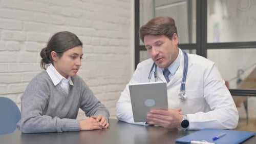 Doctor and Patient Discussing Medical Information on Tablet
