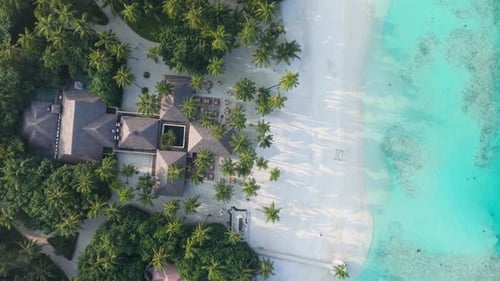 Aerial View of a Luxurious Resort in the Maldives Featuring Pristine White Sand Beaches and