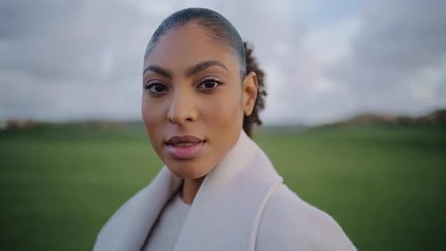 Woman Posing with Ponytail on Green Field