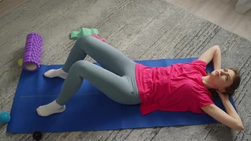 Top View of a Woman Pumping Her Abs on a Mat