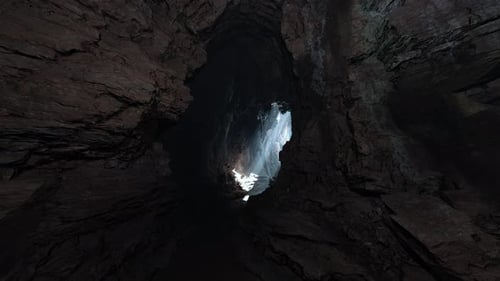 Enchanting Cave Filled with Dark Rocks Illuminated By a Soft Volume of Light