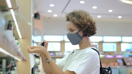 In a Large Cosmetic Store a Woman Chooses a Perfume