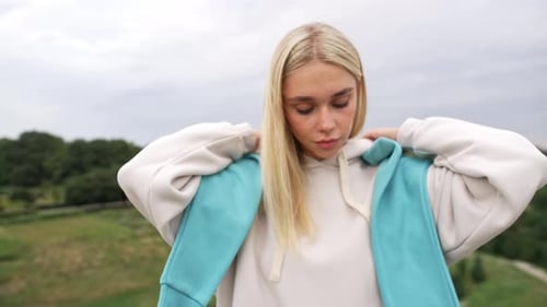 Caucasian Beautiful Woman Puts on a Hood