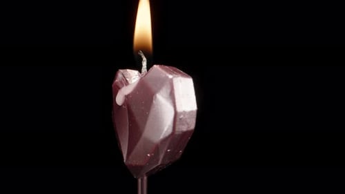 Metallic Heart Shaped Candle Being Lit