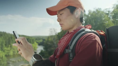 Man On Cliff Using Smartphone in Nature