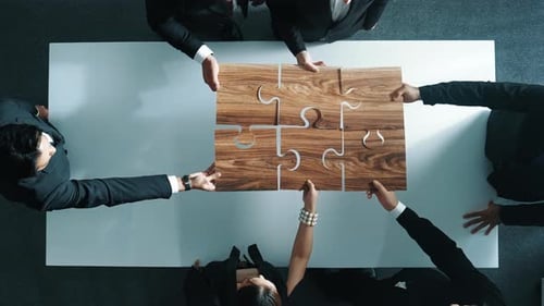 Team Builds Puzzle Together at Table Birds Eye View