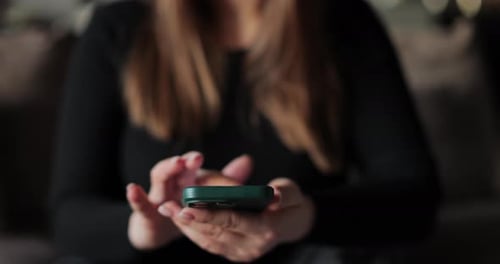 Woman uses smartphone, close up on phone