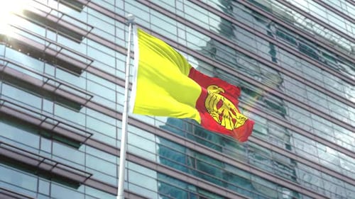 Waving Flag with Eagle Emblem on Modern Corporate Building