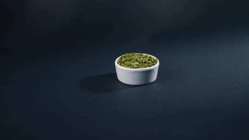 on a Black and Blue Background Flat White Bowl with Pumpkin Seeds Healthy Eating Autumn Harvest
