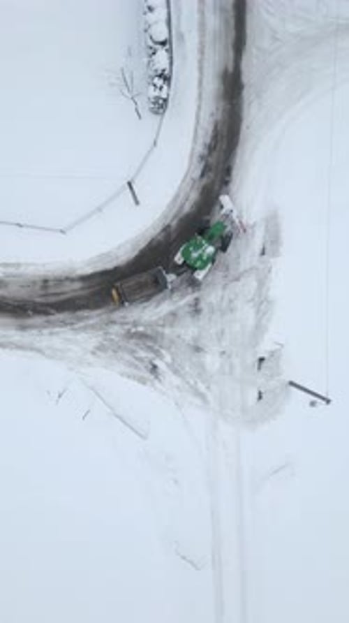 Top View Of Snow Removal Tractor On Road In Winter