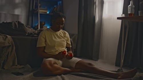 Woman Sitting on Floor Taking Pills
