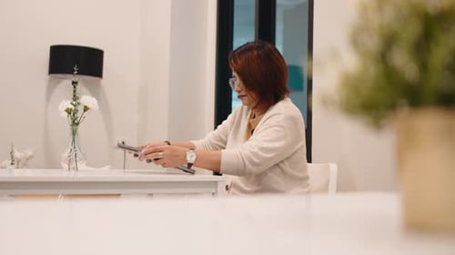 Woman Working on Laptop Indoors at Table