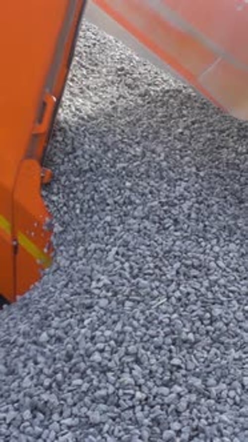 A Dump Truck is Dumping Gravel at the Excavation Site Stock Footage Close Up of Unloading Process of