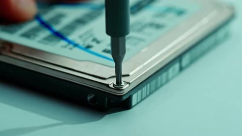 Screwdriver Unscrewing Screw From Hard Drive